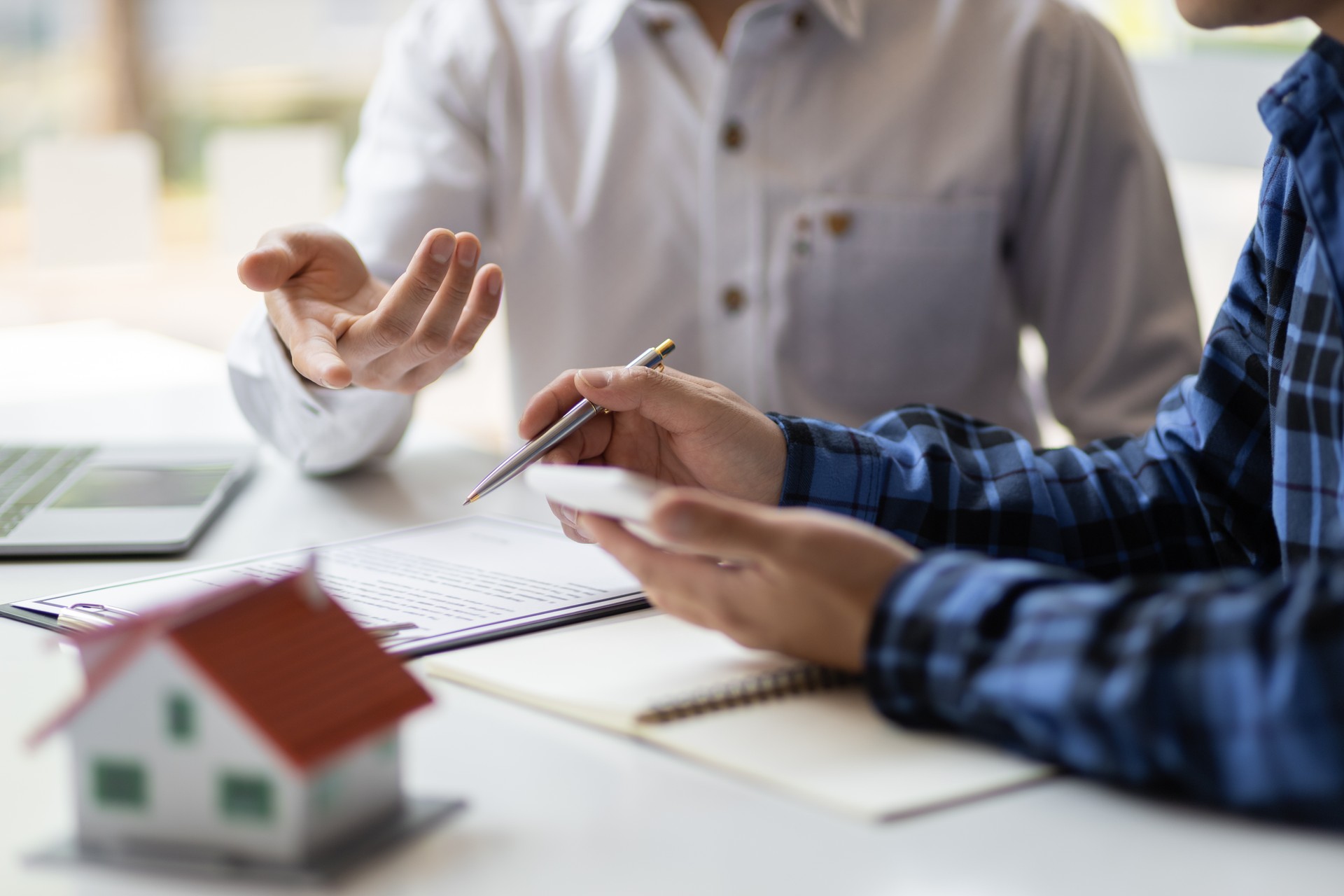 Real estate agents are discussing legal signing of home purchases, renting and mortgage agreements.